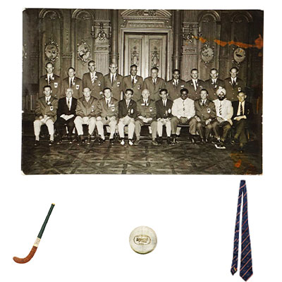 1964 OLYMPIC GOLD MEDAL WINNING  INDIAN HOCKEY TEAM SIGNED HOCKEY STICK ALONG WITH ORIGINAL BALL AND A TIE